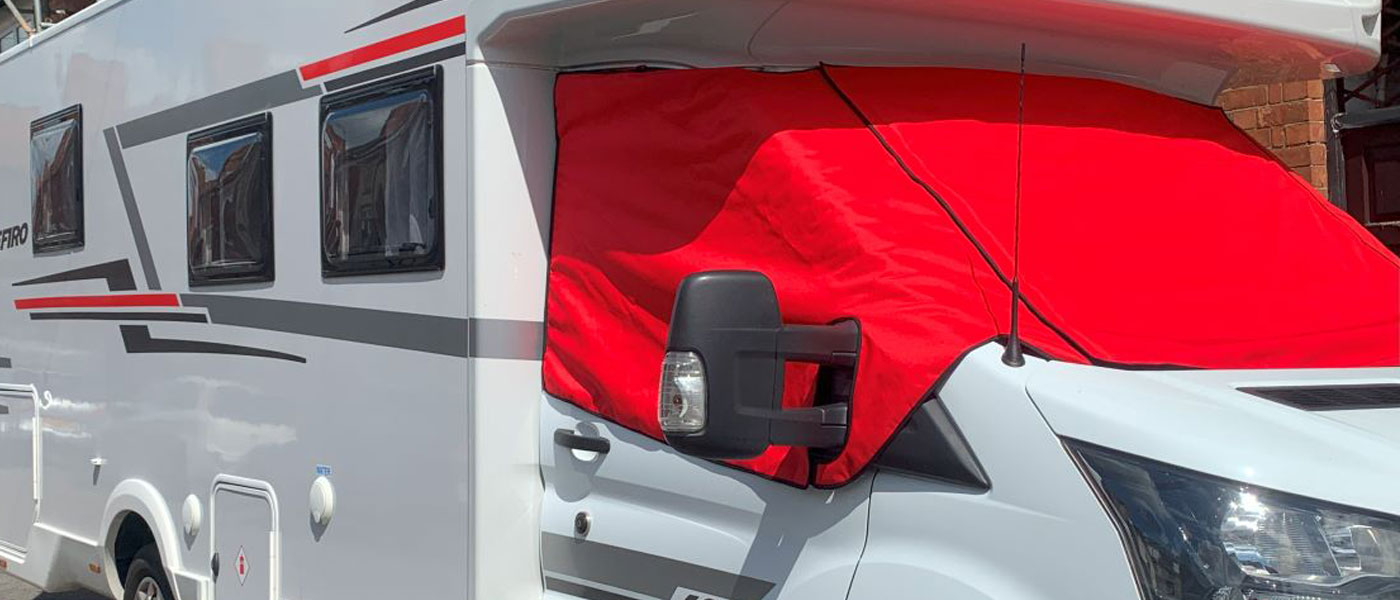 Red thermal screen cover fitted to a Ford Transit base Motorhome